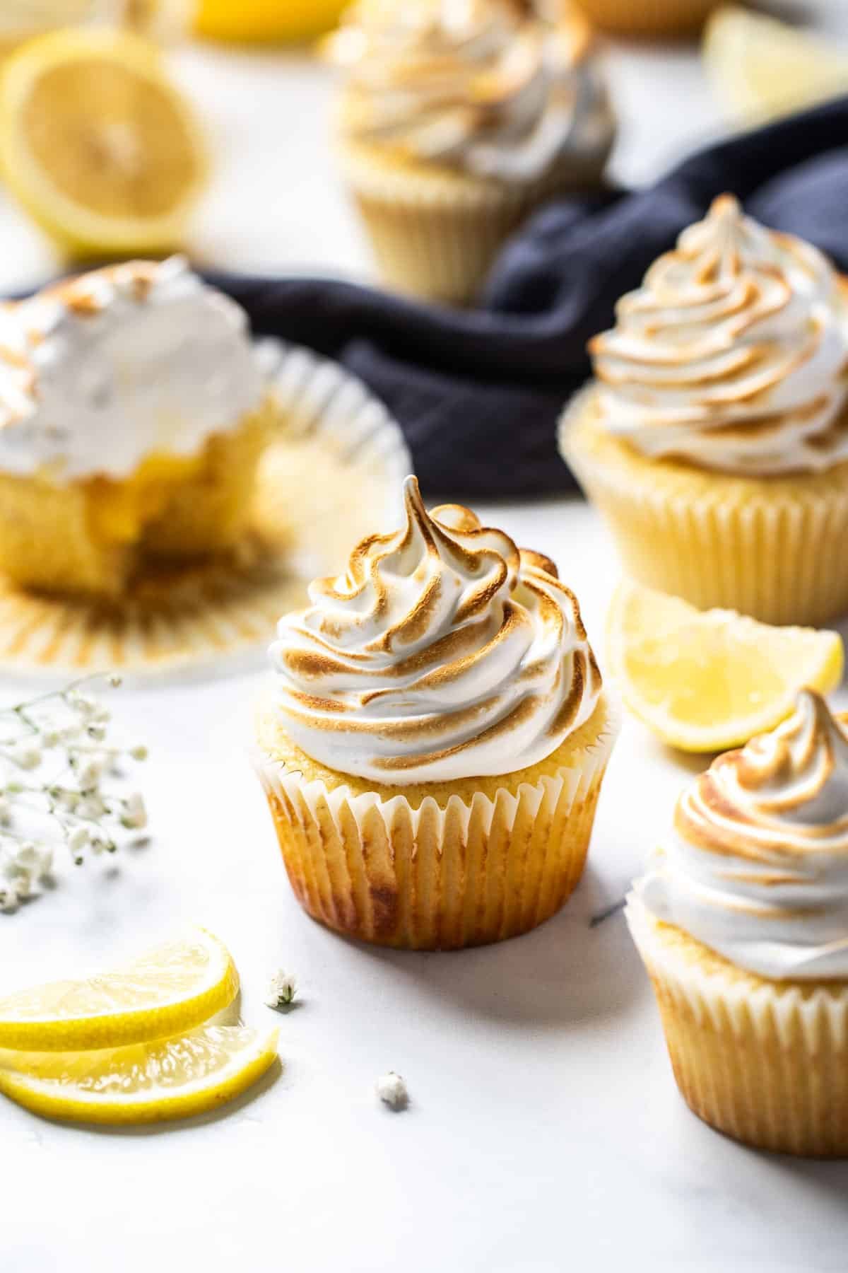 lemon meringue cupcakes, arranged on a table.