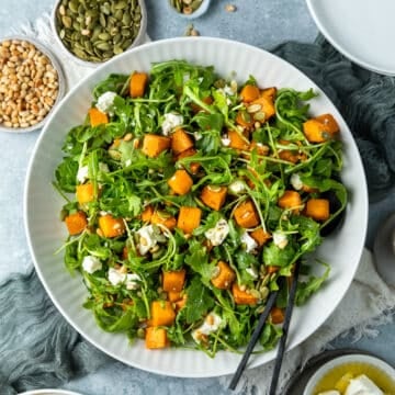 a bowl of roast pumpkin salad on a table.