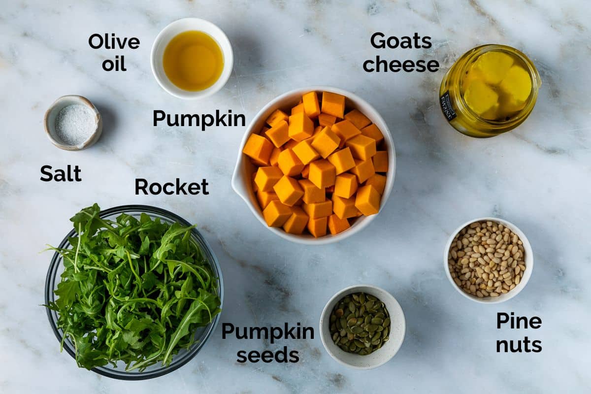 all ingredients for roast pumpkin salad, laid out on a table.