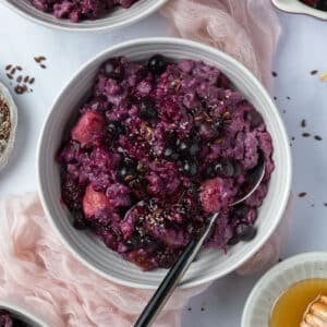a bowl of berry porridge on a table.