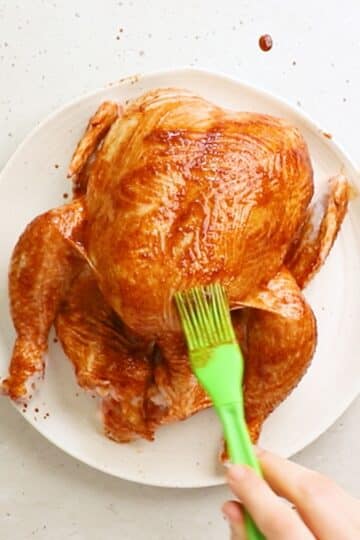 a whole chicken coated with seasoning mixture.