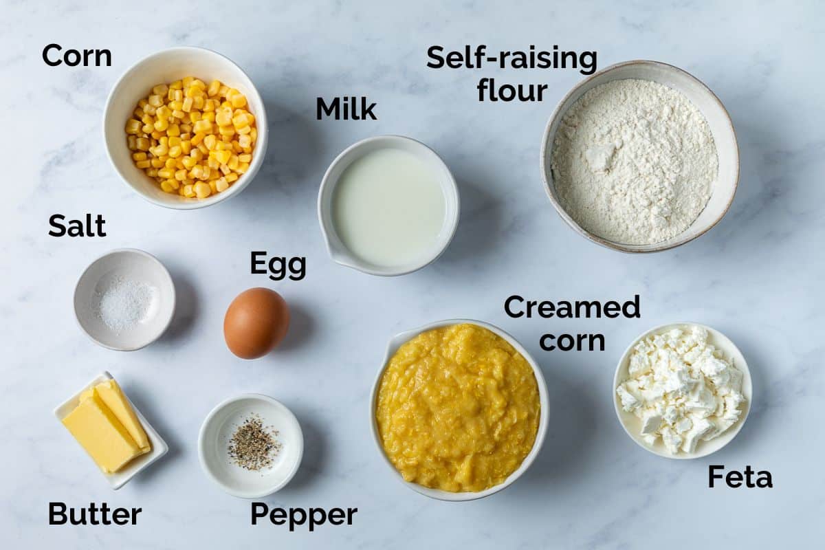 all ingredients for creamed corn fritters, laid out on a table.