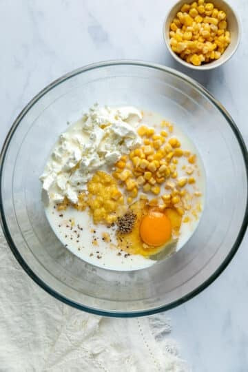 Wet ingredients for corn fritters in a bowl.