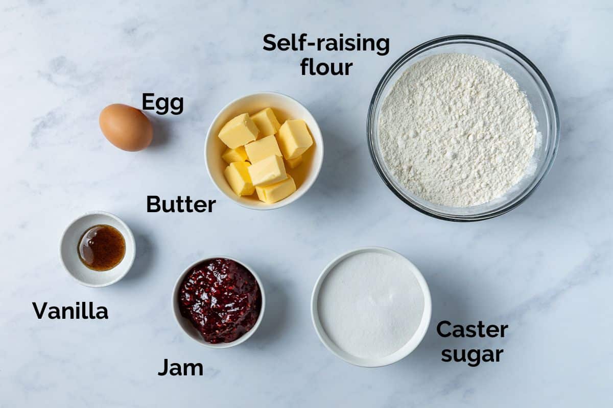 all ingredients for jam drop biscuits, laid out on a table.