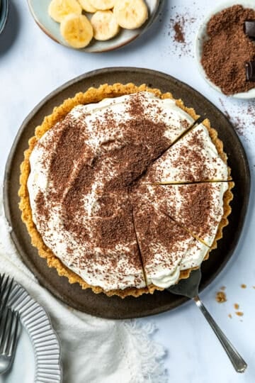 top view of a finished banoffee pie, cut into slices.