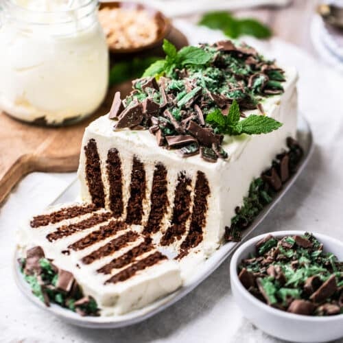 chocolate ripple cake, topped with peppermint crisp and sliced on a plate.