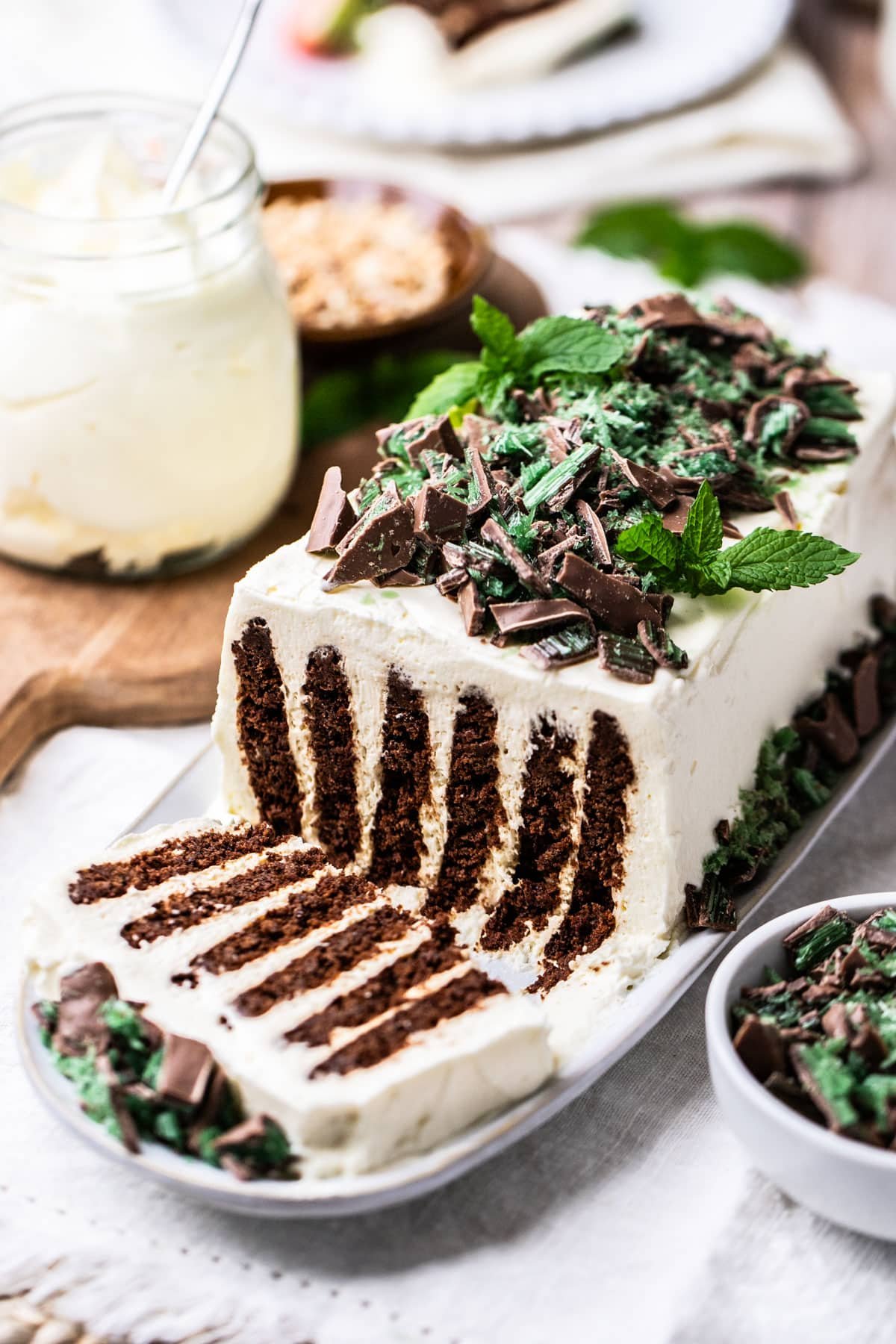 finished chocolate ripple cake on a plate, decorated with mint and chocolate.