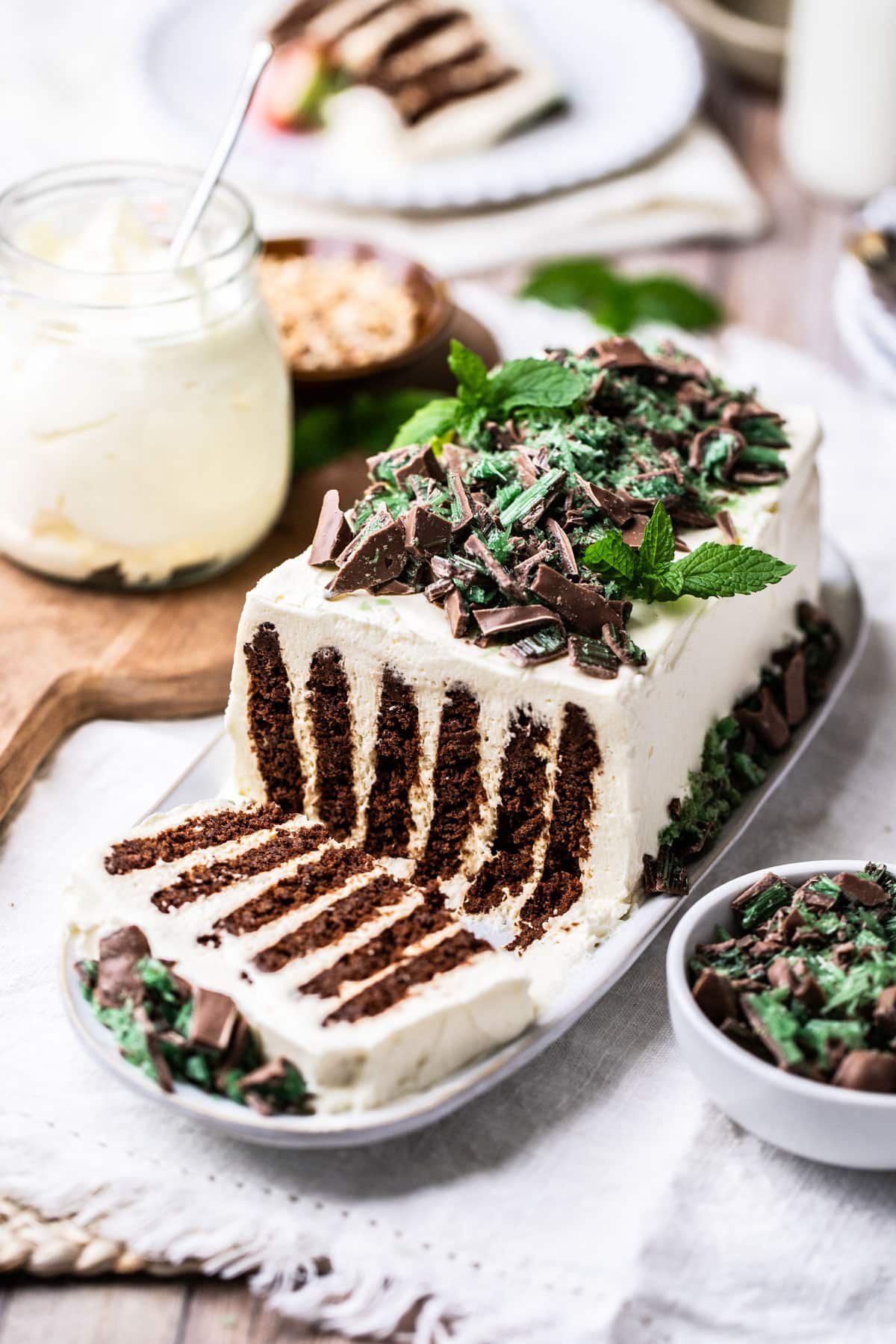 a plate of chocolate ripple cake topped with peppermint.