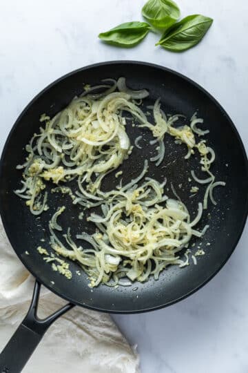 onion and garlic cooked in a pan.