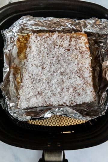 pork belly in an air fryer. The skin is covered with a sea salt crust.