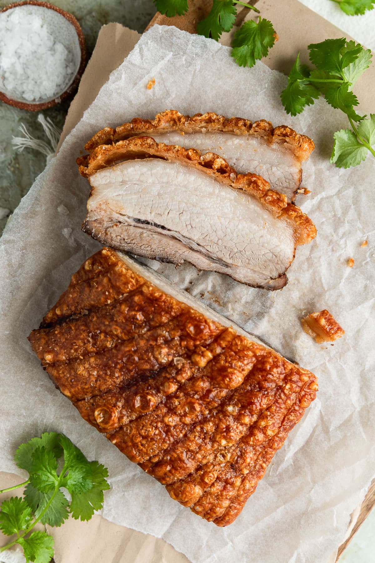 pork belly, sliced on a wooden board.