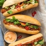 Banh mi (pork rolls) on a tray with a dish of chilli mayo.