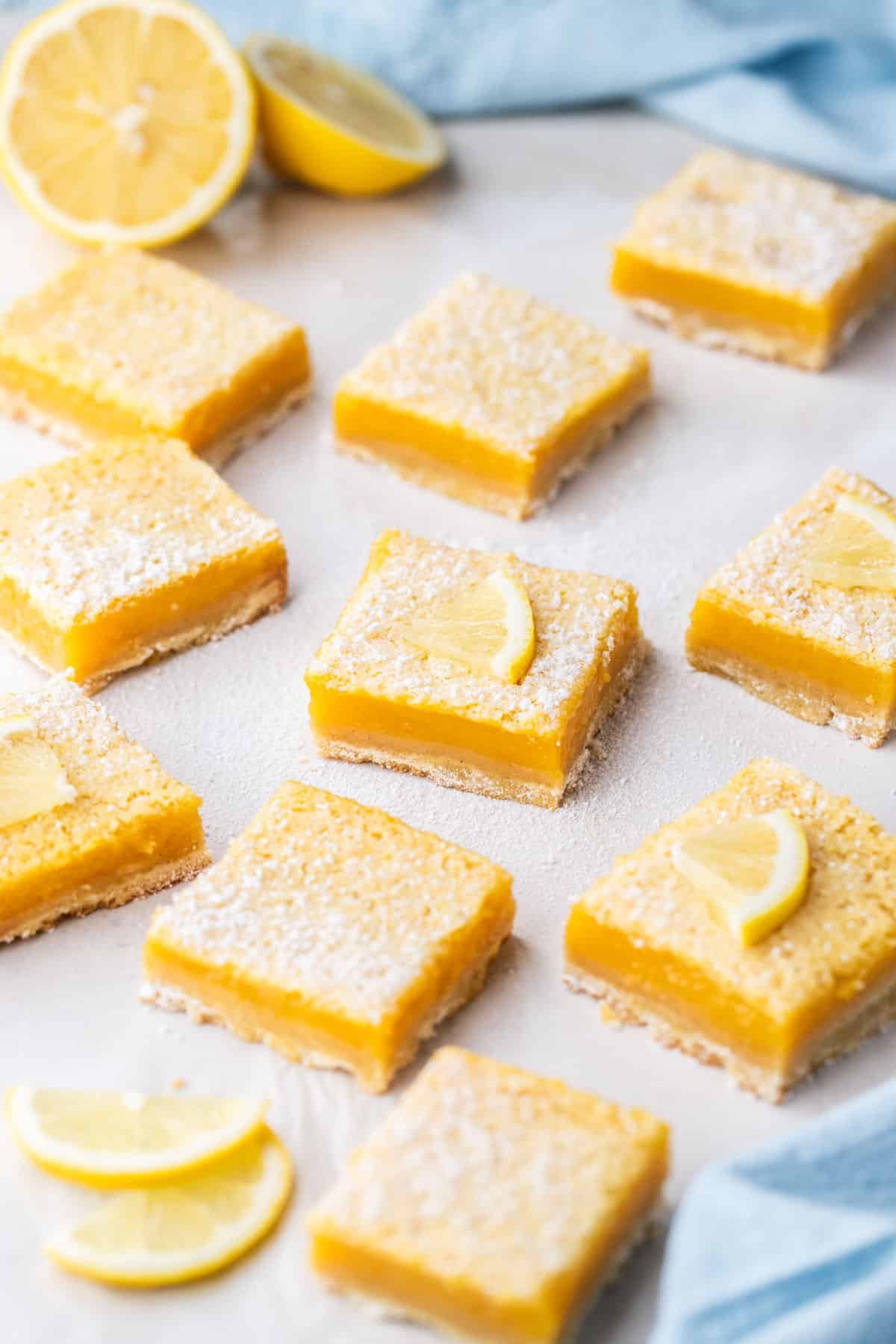 lemon curd slices, arranged on a table with lemons.