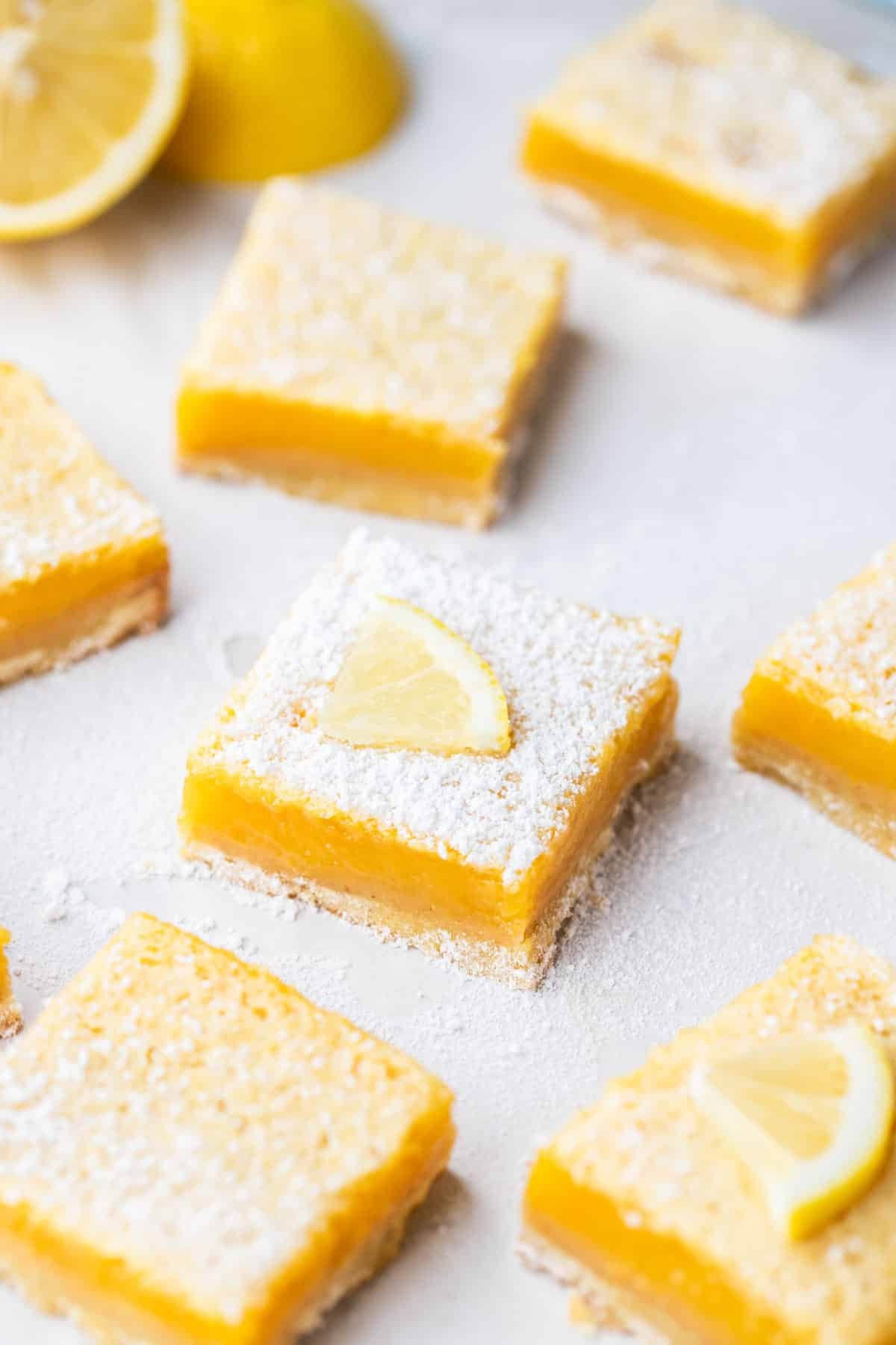 lemon curd slices on a table, topped with a dusting of icing sugar.