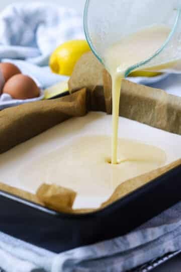 lemon mixture being poured onto the shortbread base.