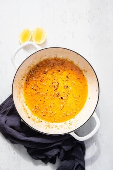 a cooking pan with oil, garlic and chilli.