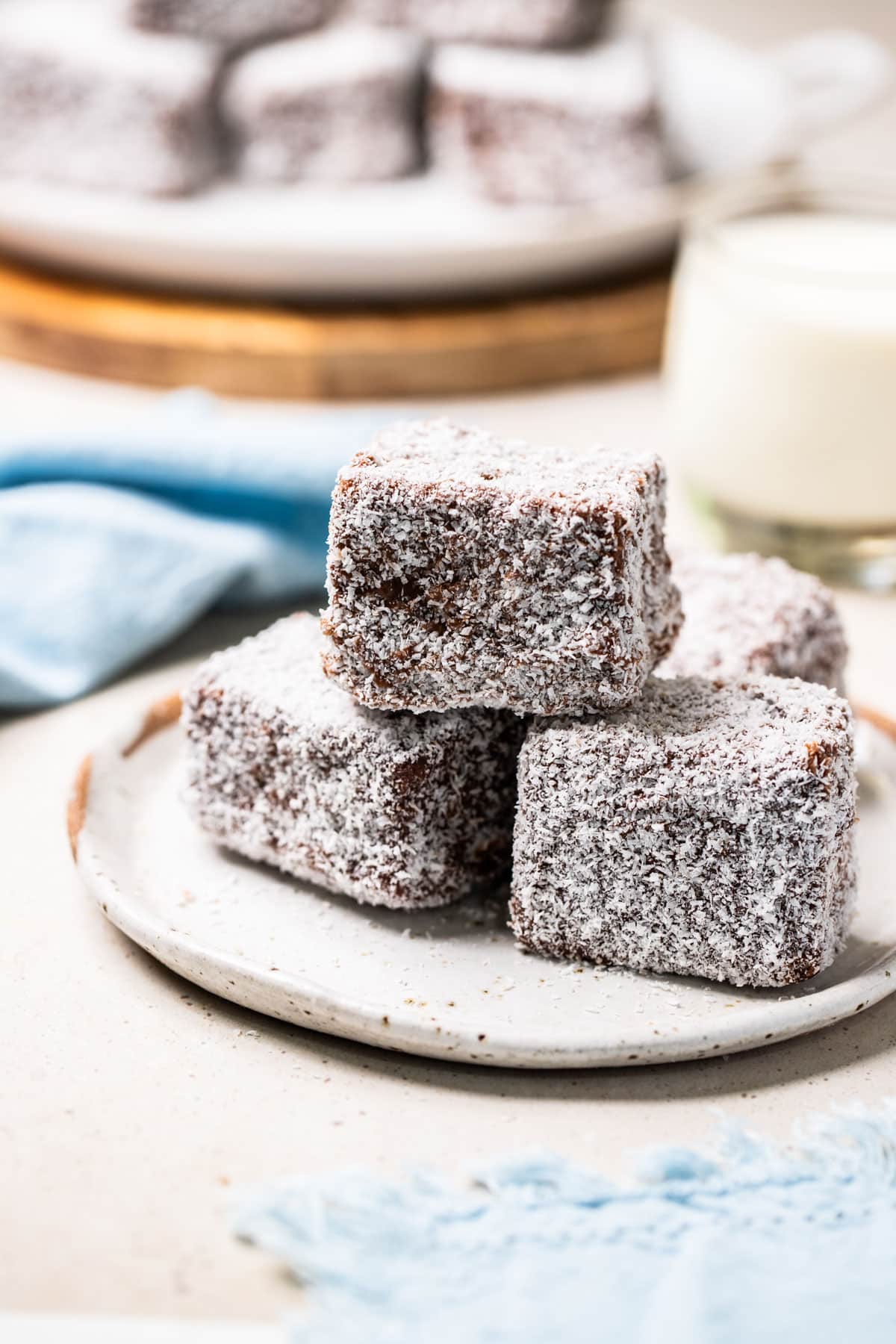 a plate of lamingtons on a table.