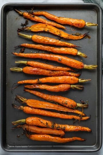 finished roasted carrots arranged on a baking tray