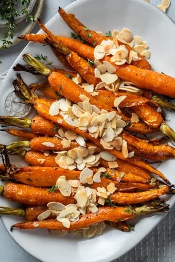 finished Dutch carrots in a serving dish, topped with almonds and feta.