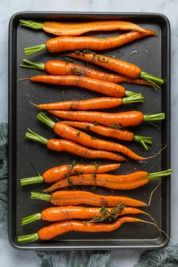 dutch carrots arranged on a baking tray.