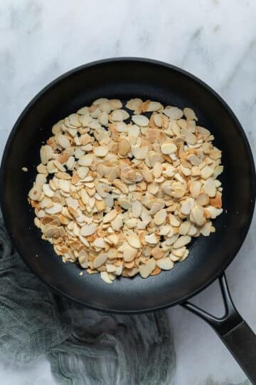 toasted flaked almonds in a pan.