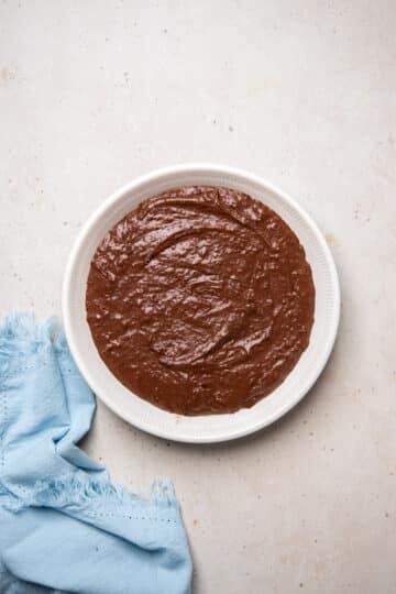 chocolate pudding batter spread into a baking dish.