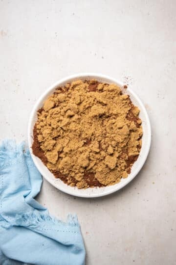 brown sugar and cocoa powder spread over the top of pudding batter in a baking dish.